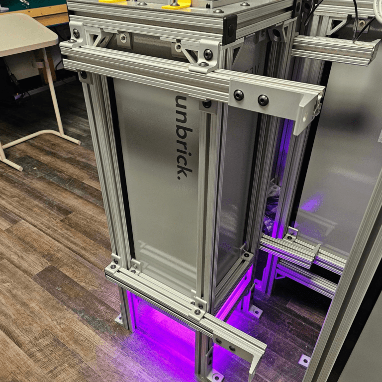 G2V Optics Class AAA solar simulator the Sunbrick emitting a purple light in its dual stand configuration allowing it to operate vertically or horizontally.
